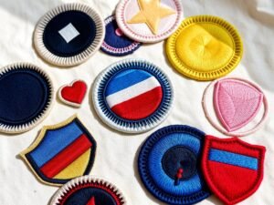 Collection of colorful embroidered patches in various shapes and designs.