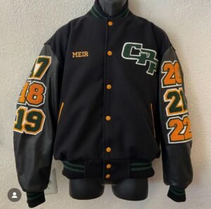 Black varsity jacket with orange and gold embroidered number patches