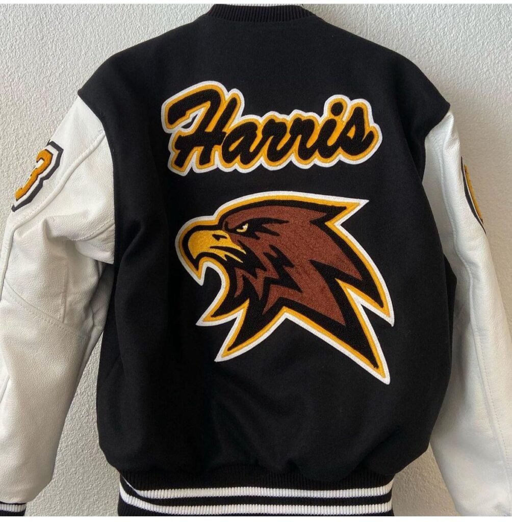 Custom black and cream letterman jacket with gold “Harris” lettering and a red and gold hawk embroidered on the back.