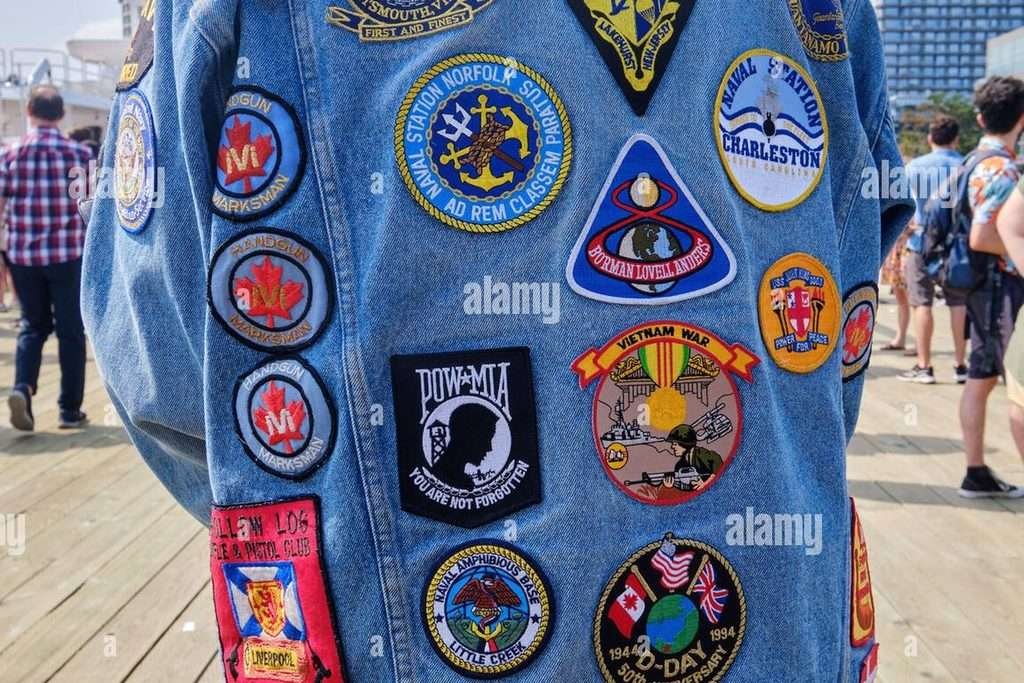 Denim jacket covered with embroidered patches used as distinct emblems