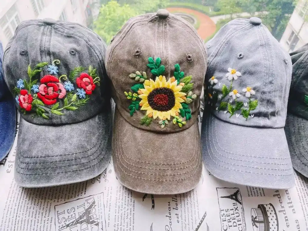 Embroidered hats showing different floral thread color combinations