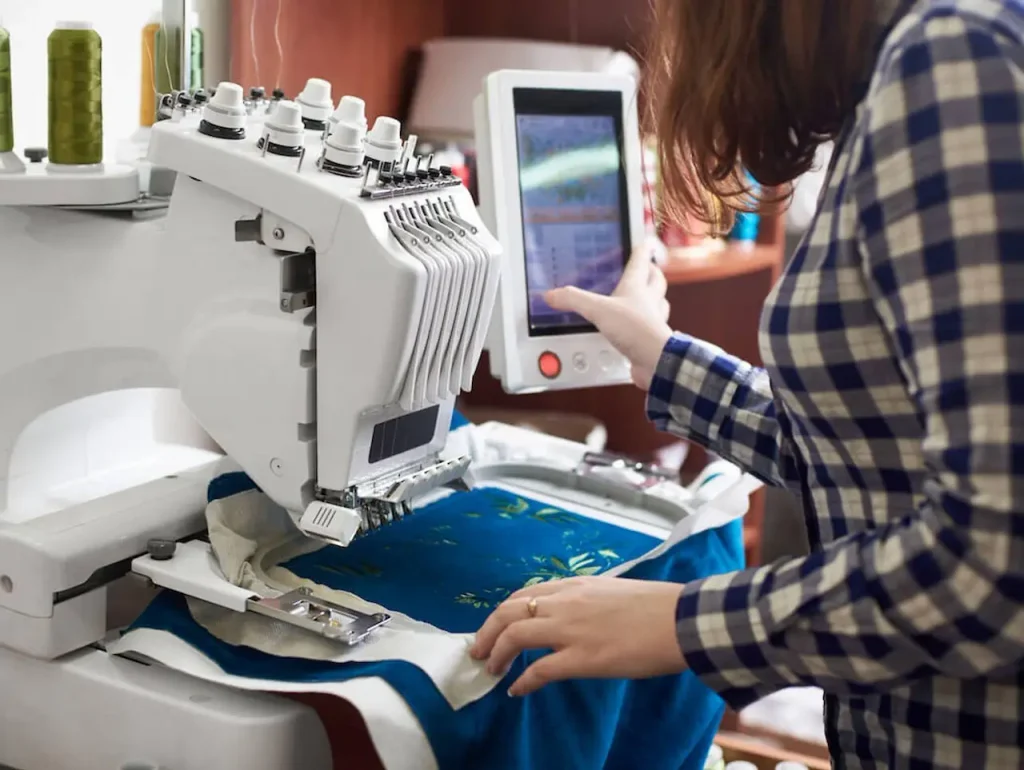 Computerized embroidery machine stitching a design onto fabric