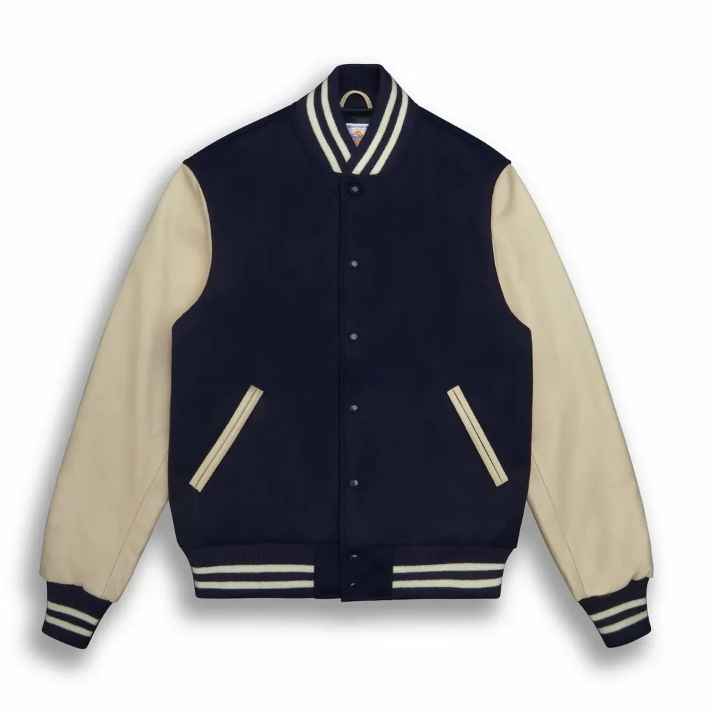 Custom varsity letterman jacket hanging on a wooden hanger, showing its contrasting sleeves, ribbed cuffs and classic design.